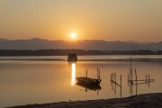 金色夕阳下的湖边船影