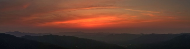 山间日落霞光映照下的群山剪影
